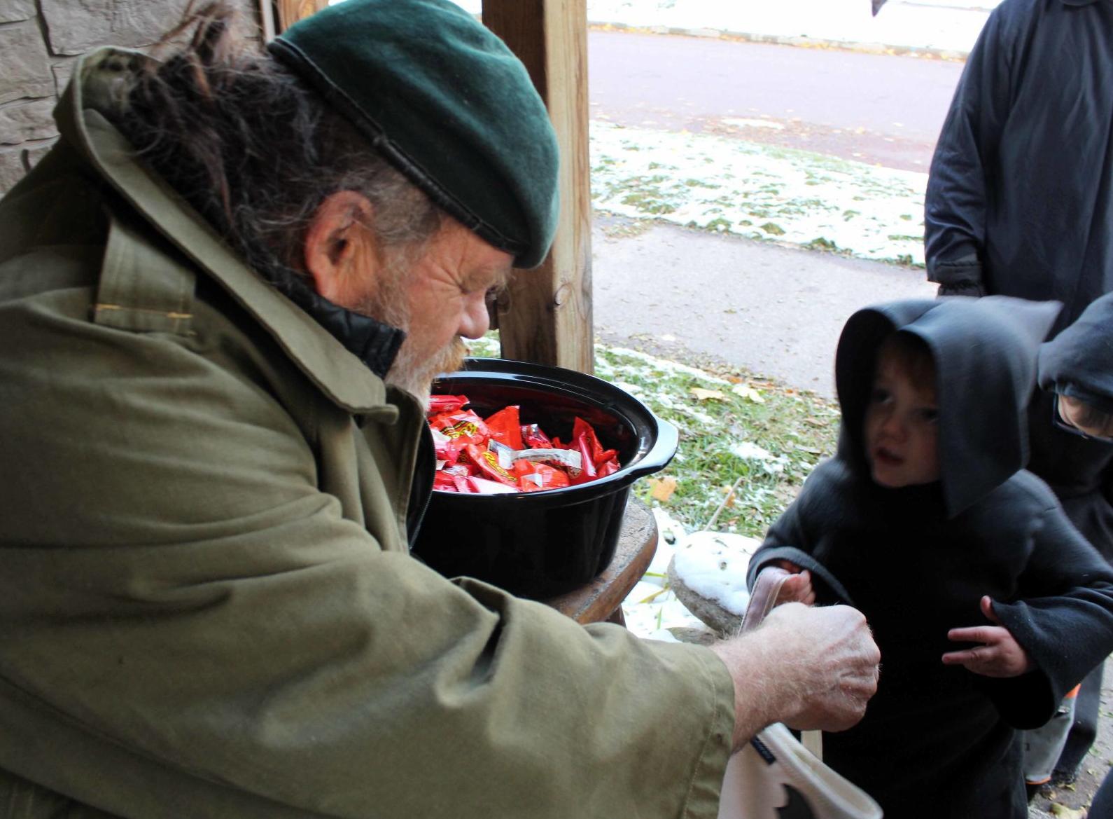 Alexander hands candy to Wayne